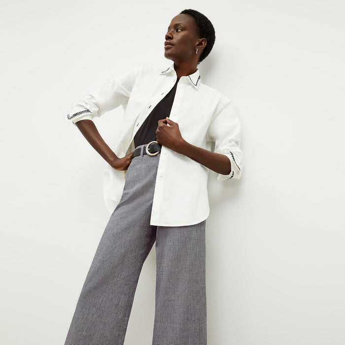 front image of a woman wearing the mila button down in white