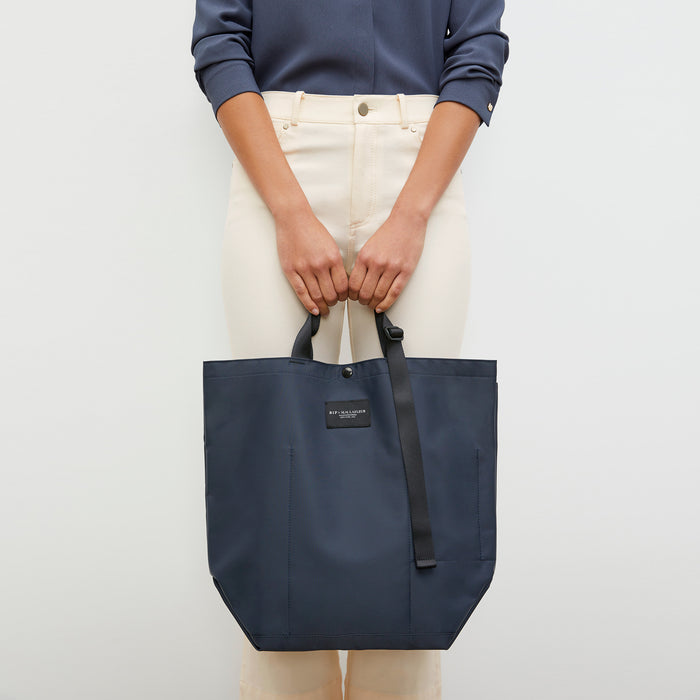 Front image of a woman wearing the Bags in Progress x MM Carry All Tote  in Navy