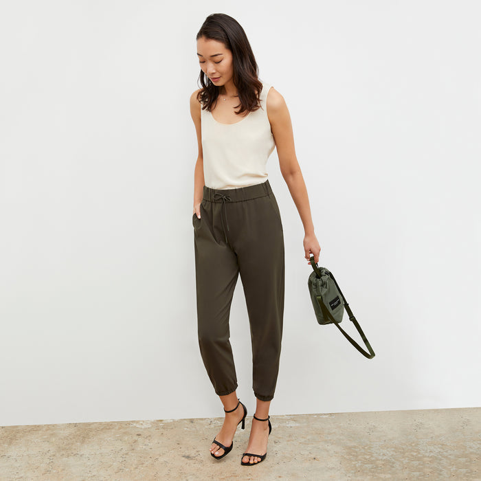 Front image of a woman wearing the Bags in Progress x MM Padded Mini Bucket Bag in Khaki Green