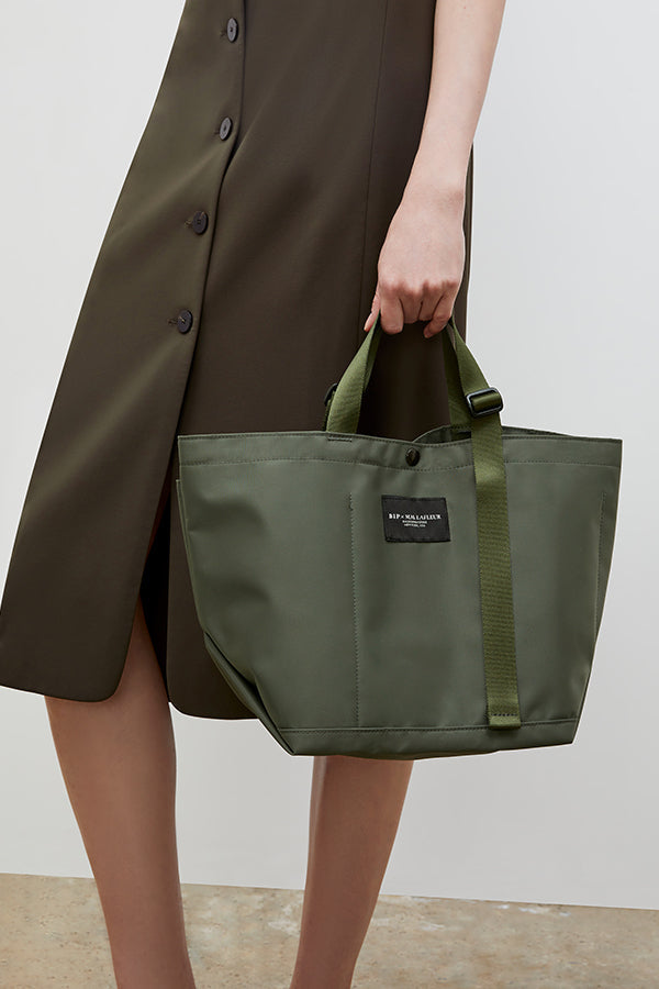 Front image of a woman wearing the Bags in Progress x MM Small Carry All Tote  in Khaki Green | Grid Hover | Exclude