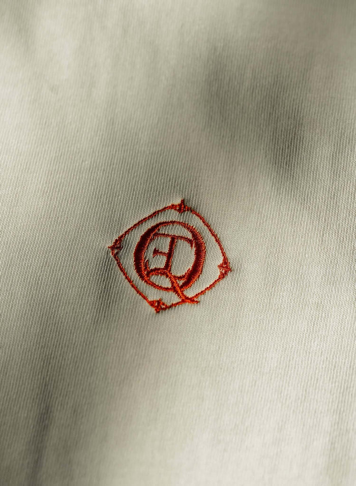 Embroidered monogram logo on monogram embroidered cotton t-shirt in French vanilla.