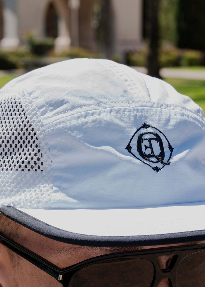 Monogram Performance Mesh Cap White showcasing breathable mesh panels and signature Éclectique logo.
