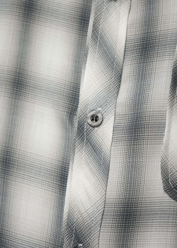 Close-up of the Monotone Plaid Button-Up Shirt showcasing the intricate tonal pattern and button detail.