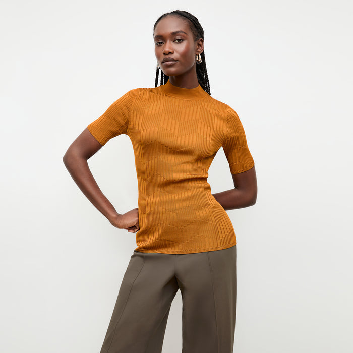 front image of a woman wearing the montean top in caramel