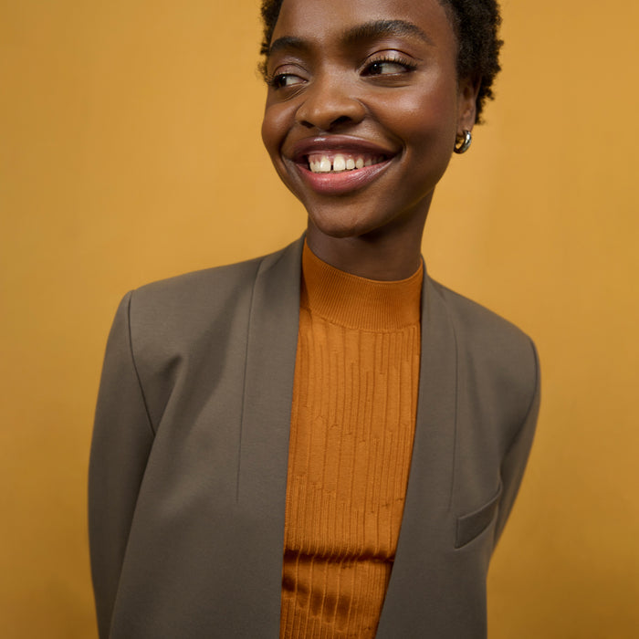 front image of a woman wearing the montean top in caramel
