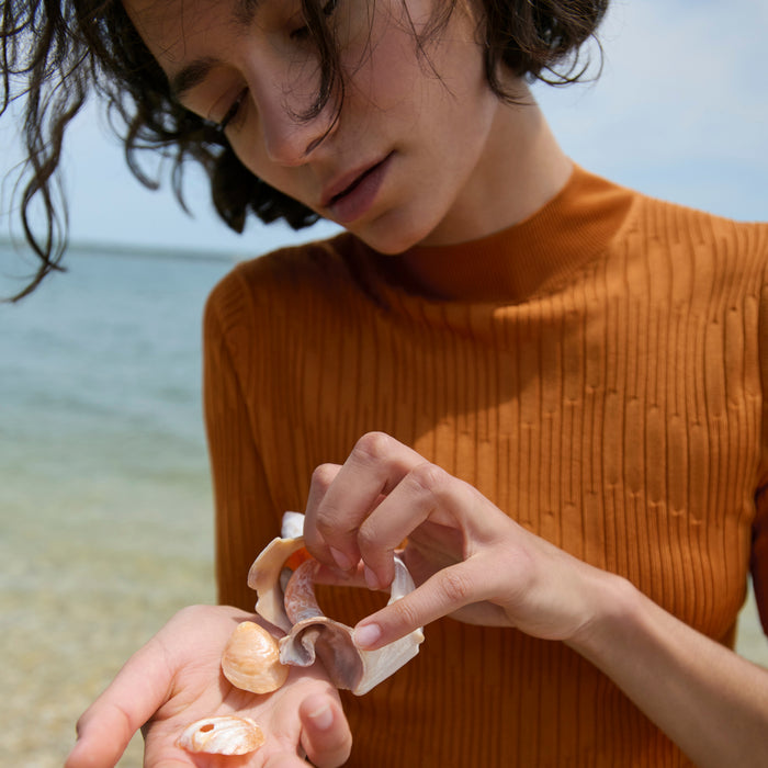 front image of a woman wearing the montean top in caramel