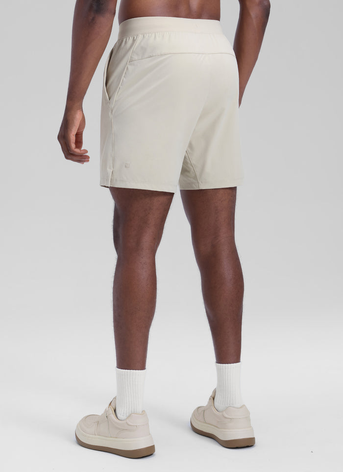 CRZ YOGA Men's Motion Workout Classic FIt Quick Dry Pocket Shorts  7" Mojave Tan