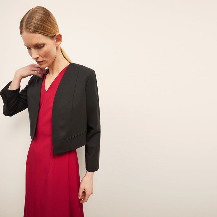 Front image of a woman standing wearing the Neale jacket in black