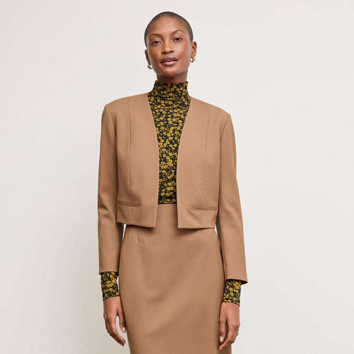 Front image of a woman standing wearing the Neale jacket in camel | Lead