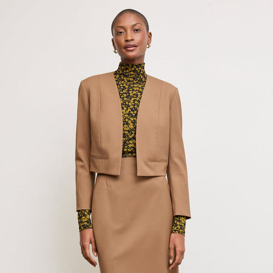 Front image of a woman standing wearing the Neale jacket in camel | Lead