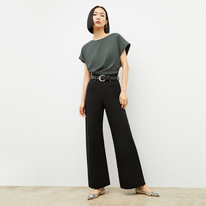 Front image of a woman wearing the Nejvi Top in Aloe