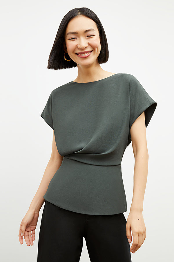 Front image of a woman wearing the Nejvi Top in Aloe | Grid | Exclude