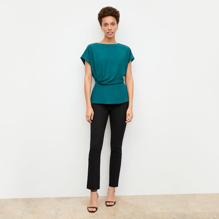 front image of a woman wearing the nejvi top in mineral blue | Lead