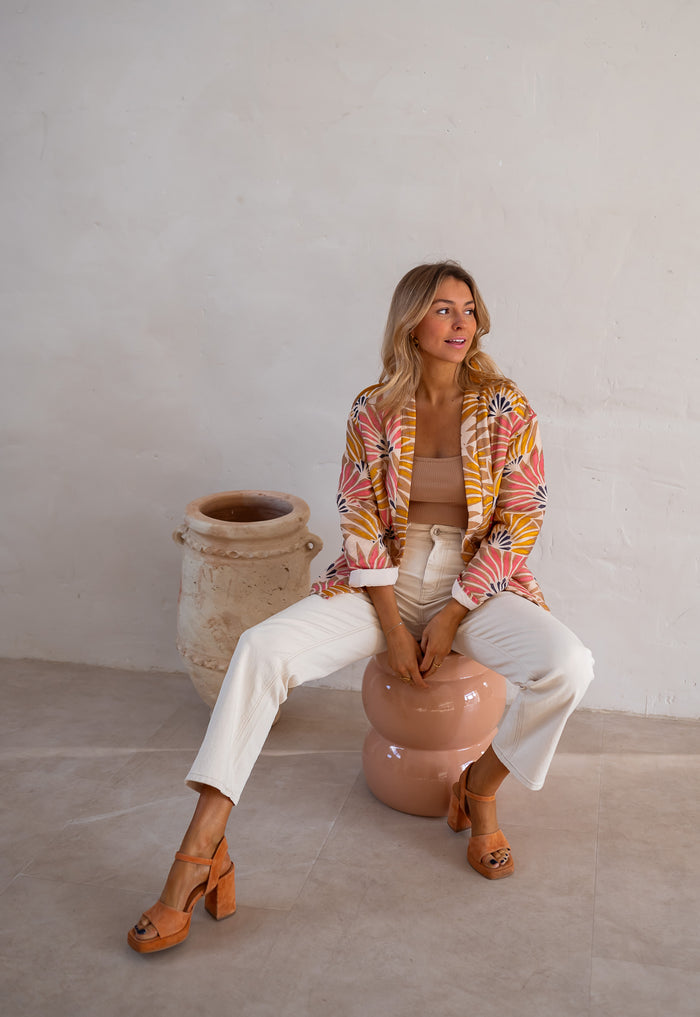 Multicolor floral jacket styled over a tank and cream jeans