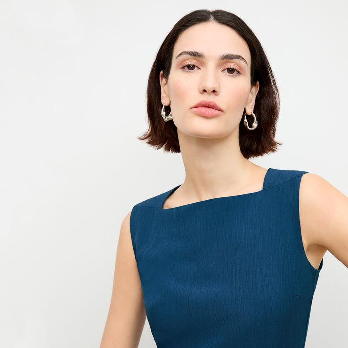 front image of a woman wearing the pauline dress in deep teal
