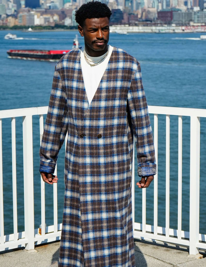Model wearing Kanso Plaid Collarless Long Coat with a city skyline background.