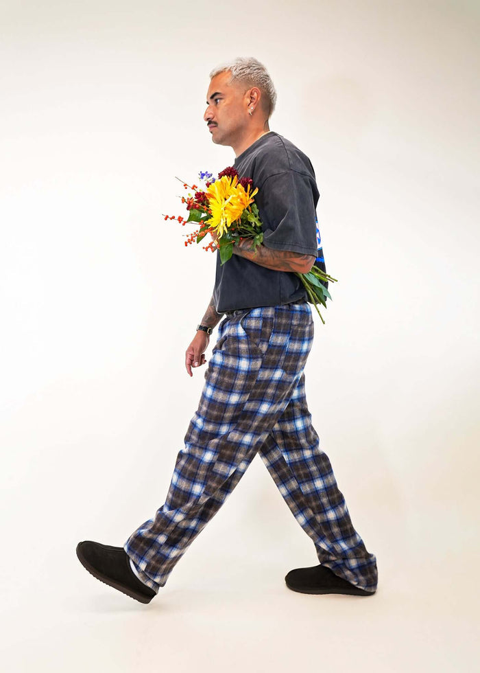 Model wearing Éclectique Mercer Plaid Pleated Trousers side walking view