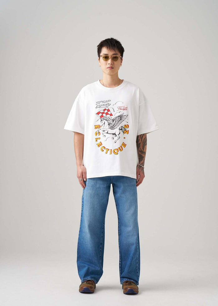 Model wearing a Racing Graphic T-shirt from Éclectique Speed Shop, styled with jeans and sunglasses.