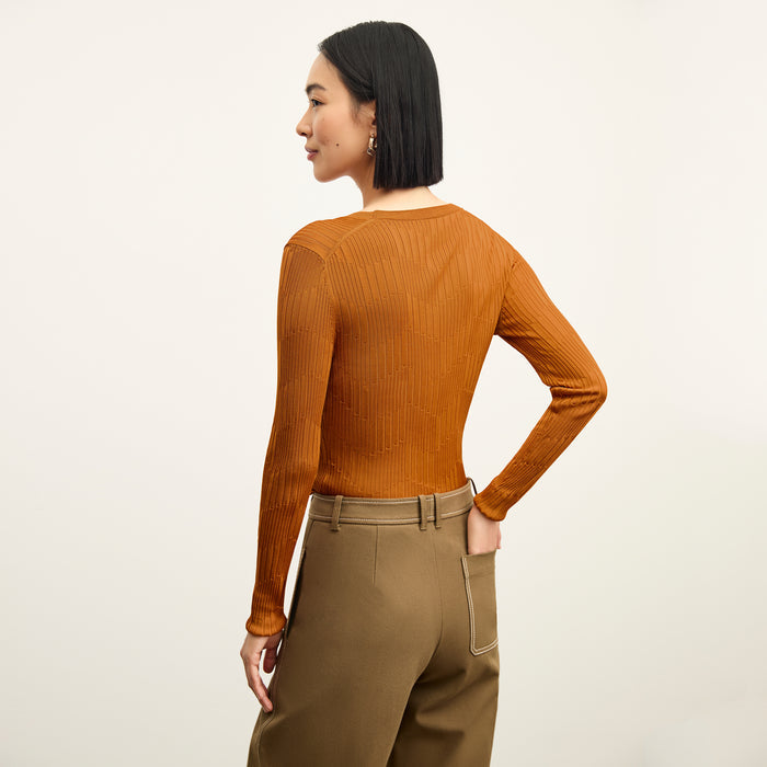 back image of a woman wearing the rae top in caramel