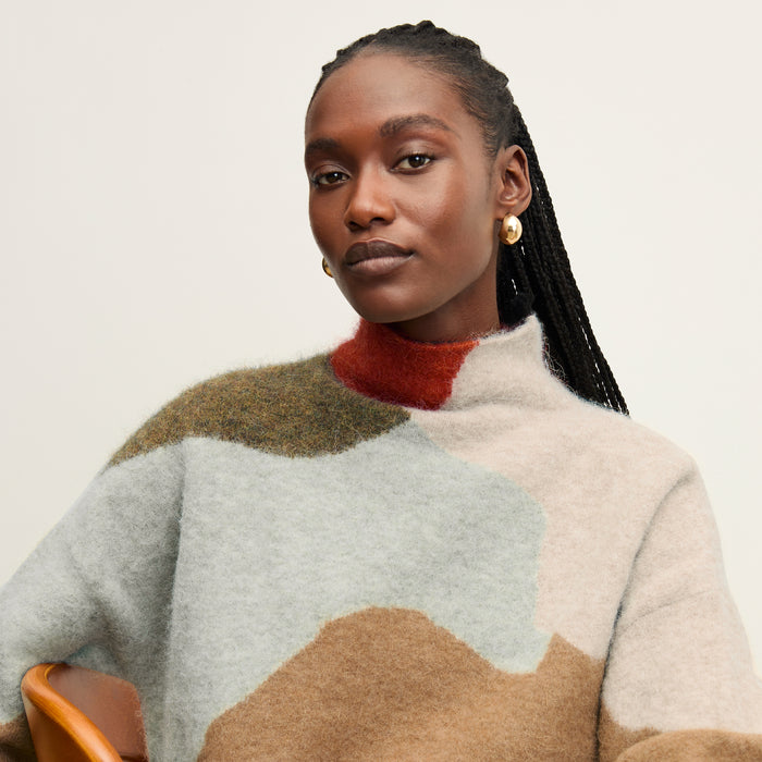 front image of a woman wearing the rajni sweater in multi