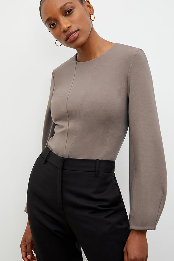 Front image of a woman wearing the Rashida top in Pebble | Exclude | Grid Hover