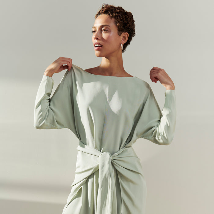Front image of a woman wearing the Rashmeen dress in Minty Green