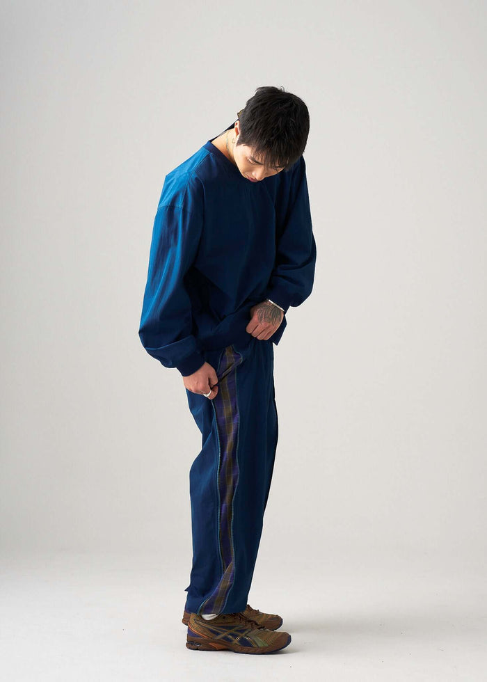 Zipper and pocket detail on the reversible windbreaker jacket.