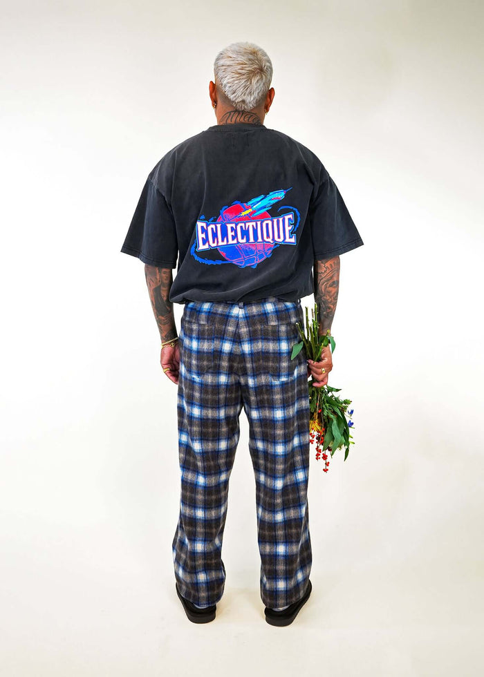 Model wearing Éclectique Rockets Graphic T-shirt back view with floral bouquet
