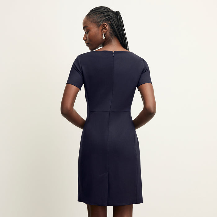 back image of a woman wearing the rosie dress in galaxy blue