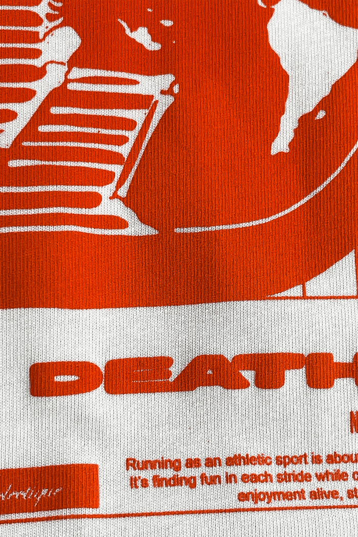 Detail of Running Graphic T-Shirt featuring vibrant orange artwork and the text DEATHPACE.