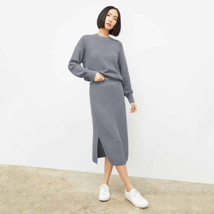 front image of a woman wearing the senga skirt in flint gray | Lead