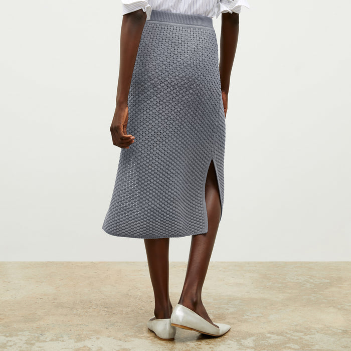 front image of a woman wearing the senga skirt in flint gray