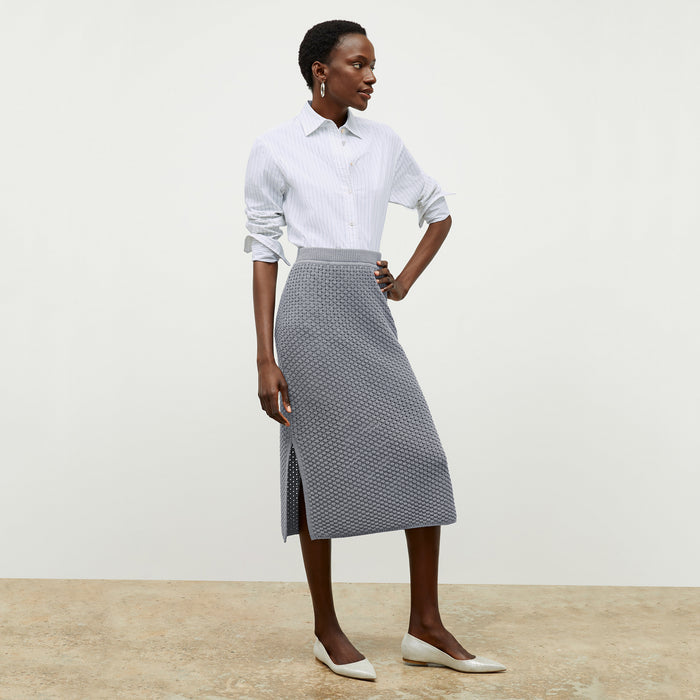 front image of a woman wearing the senga skirt in flint gray