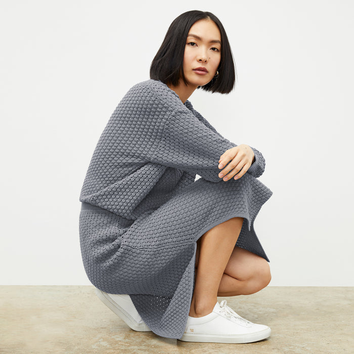 front image of a woman wearing the senga skirt in flint gray