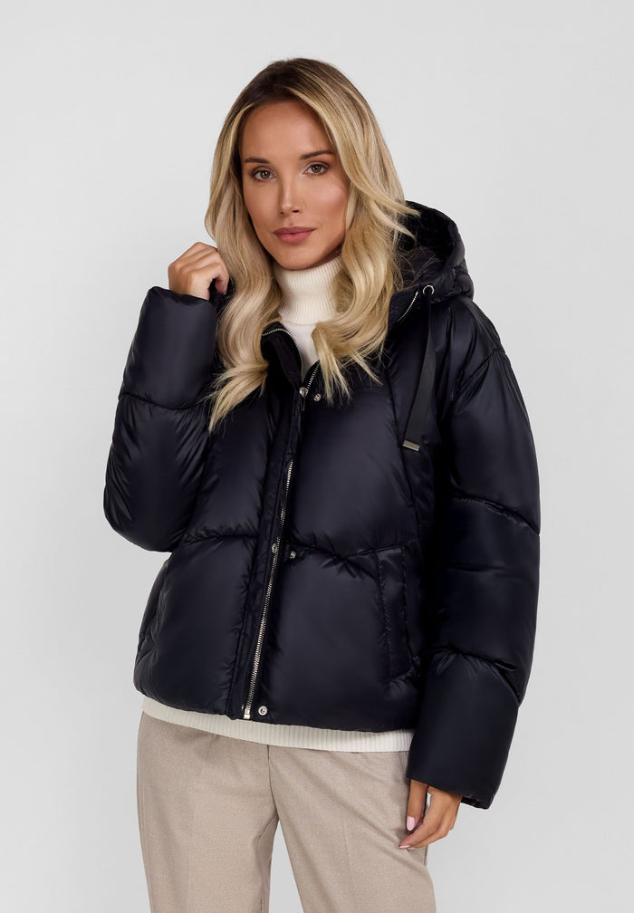 Women's short black insulated hooded jacket, front view with curved stitching and slanted pockets.