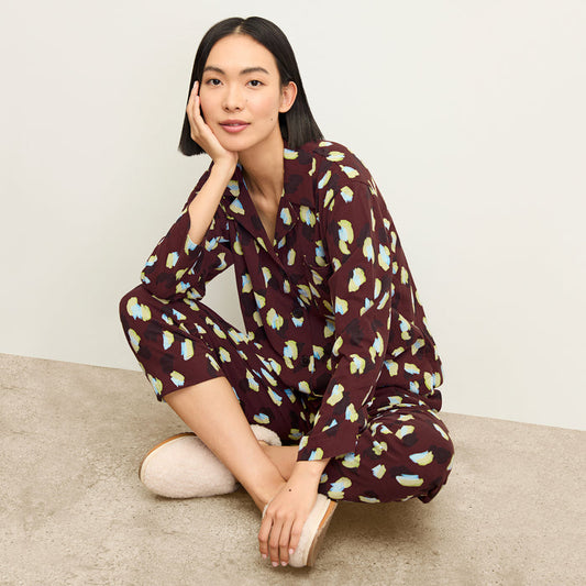 front image of a woman sitting wearing the signature pajama set in bengal print | Lead
