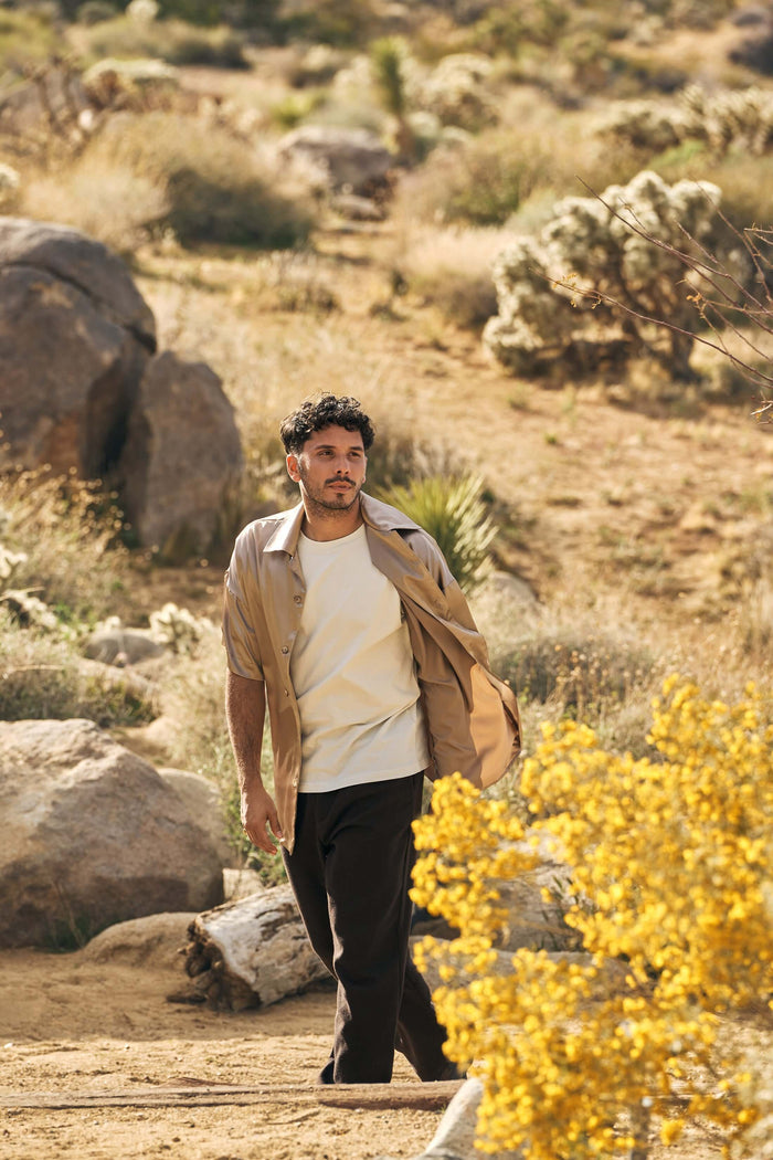model wearing beige silk bowling shirt styled outdoors