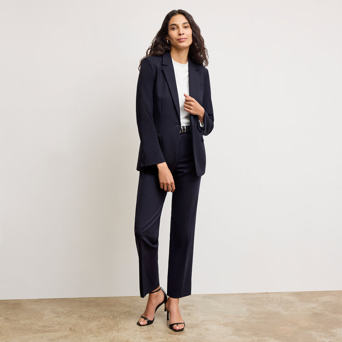 front image of a woman sitting wearing the yiyan petite blazer in galaxy blue  | Exclude
