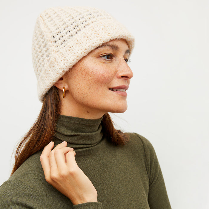 Image of a woman wearing the beanie in ivory