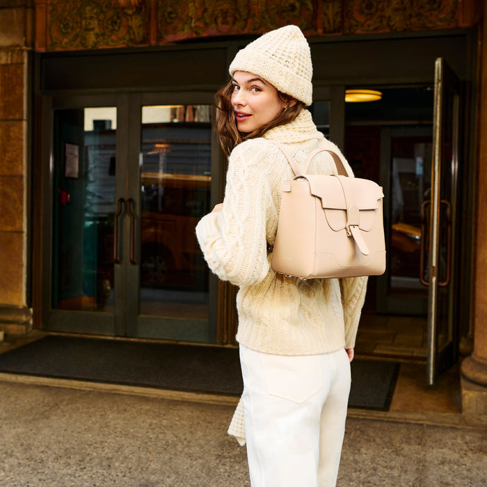 Image of a woman wearing the beanie in ivory