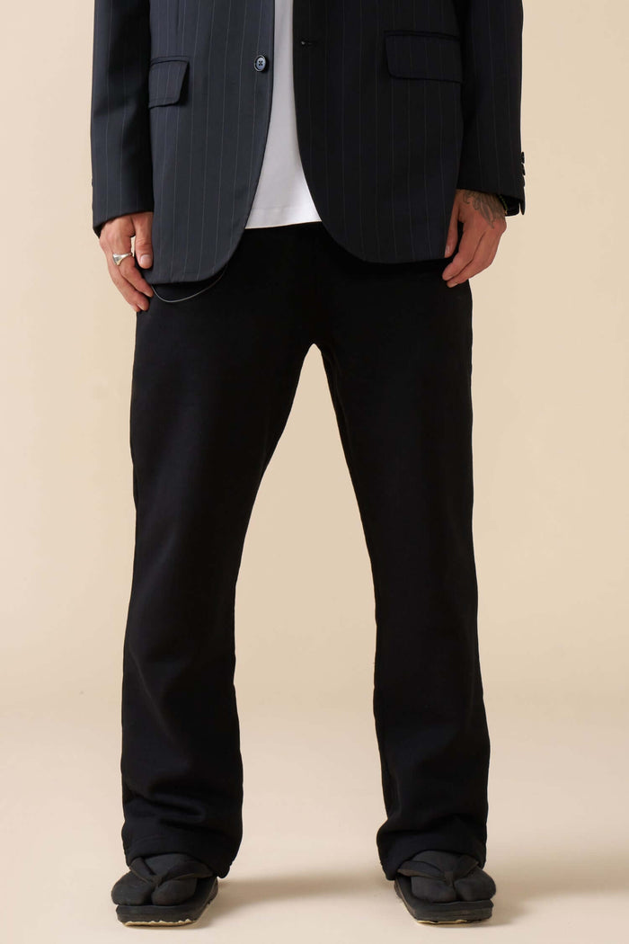model wearing black straight leg joggers front view in detail