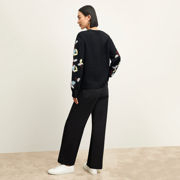 back image of a woman wearing the tish sweater in confetti