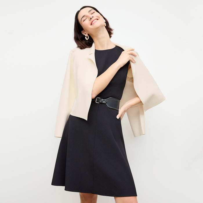front image of a woman wearing the toi dress in black
