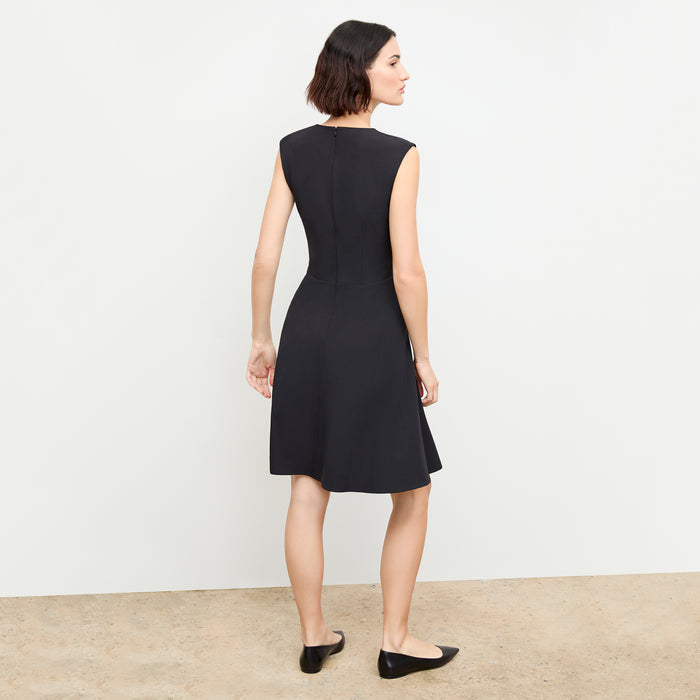 back image of a woman wearing the toi dress in black