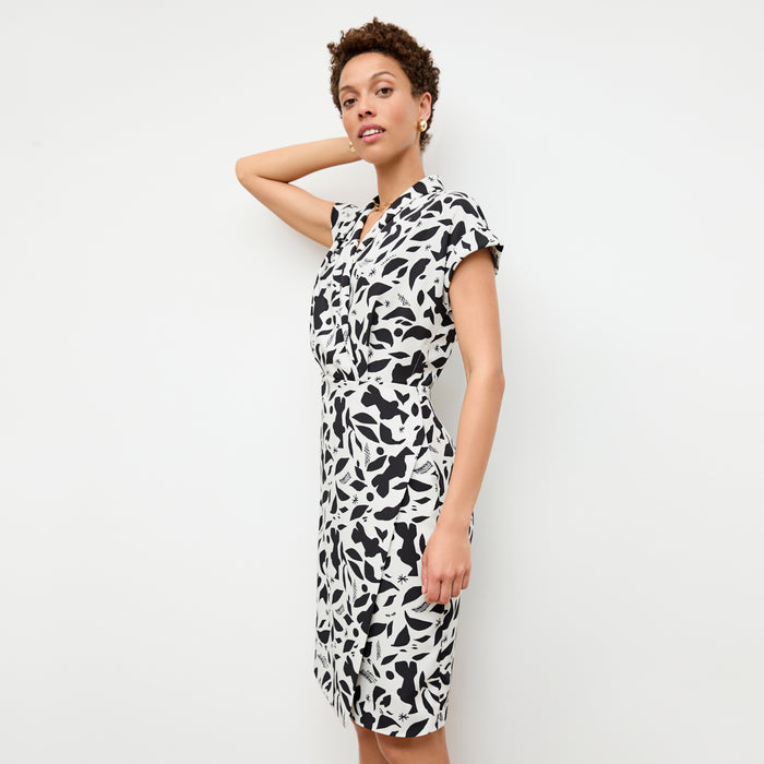 front image of a woman wearing the tory dress in icon print