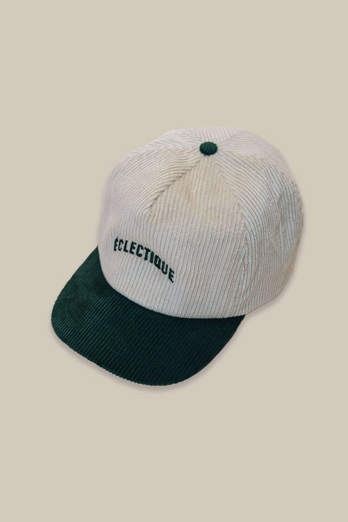 Two tone snapback hat in green and natural with block logo embroidery.