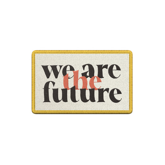 A rectangular patch by The Fall of Troy featuring a yellow border and we are the future in black and orange text on a light background.