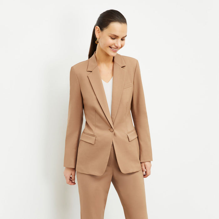 Front image of a woman standing wearing the Yiyan Blazer in Camel | Lead