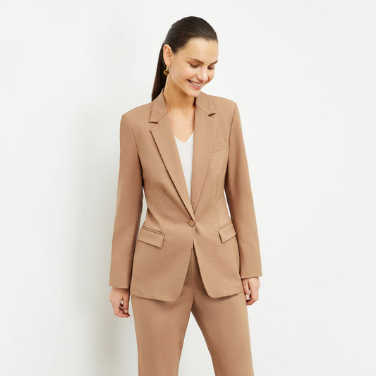 Front image of a woman standing wearing the Yiyan Blazer in Camel | Lead